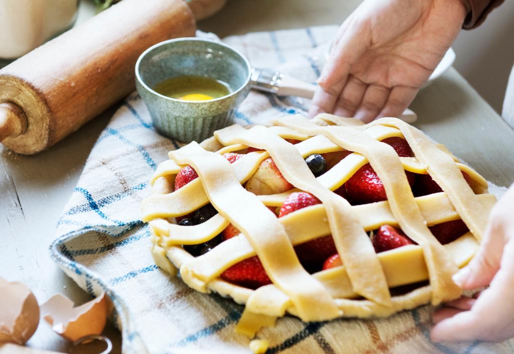 A person baking fruit pie food photography recipe idea